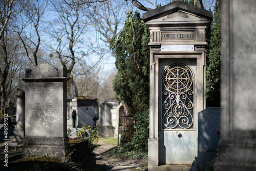 Clock like tombstone in Pere Lachaise Cemetery in Paris France