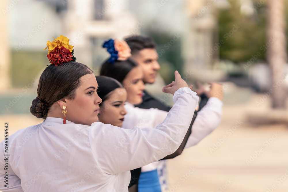 Apprentice flamenco dancer practising a pose with her partners Apprentice flamenco dancer practising a pose with her partners