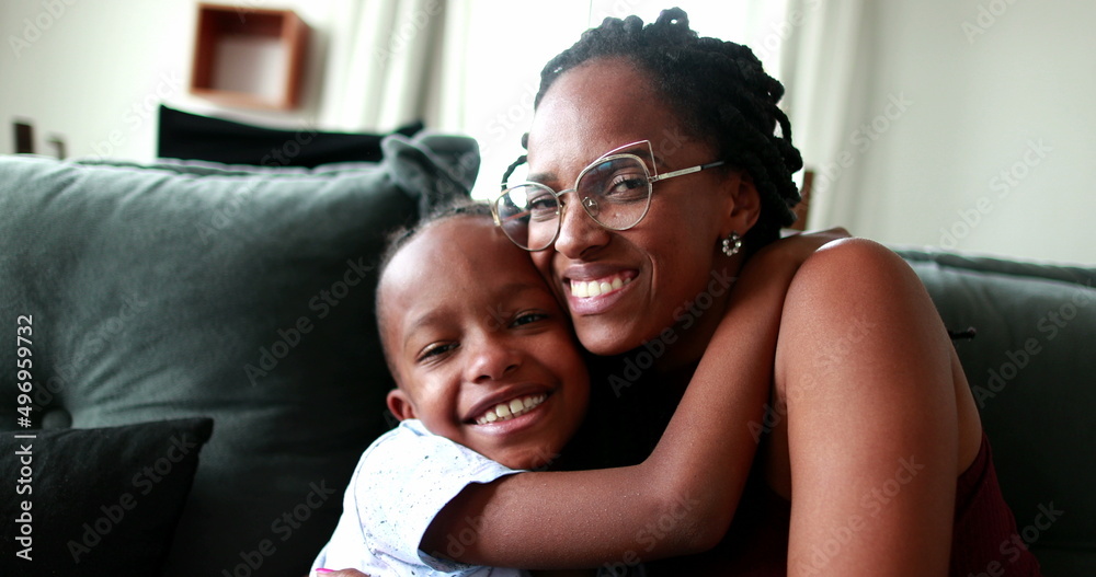 Black mixed race mother and child hugging each other. Little boy embracing mom Black mixed race mother and child hugging each other. Little boy embracing mom