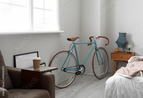 Bicycle near light wall in light bedroom