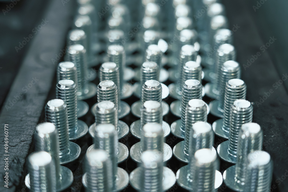 Many metal screw bolts as industrial equipment background. - obrazy, fototapety, plakaty 