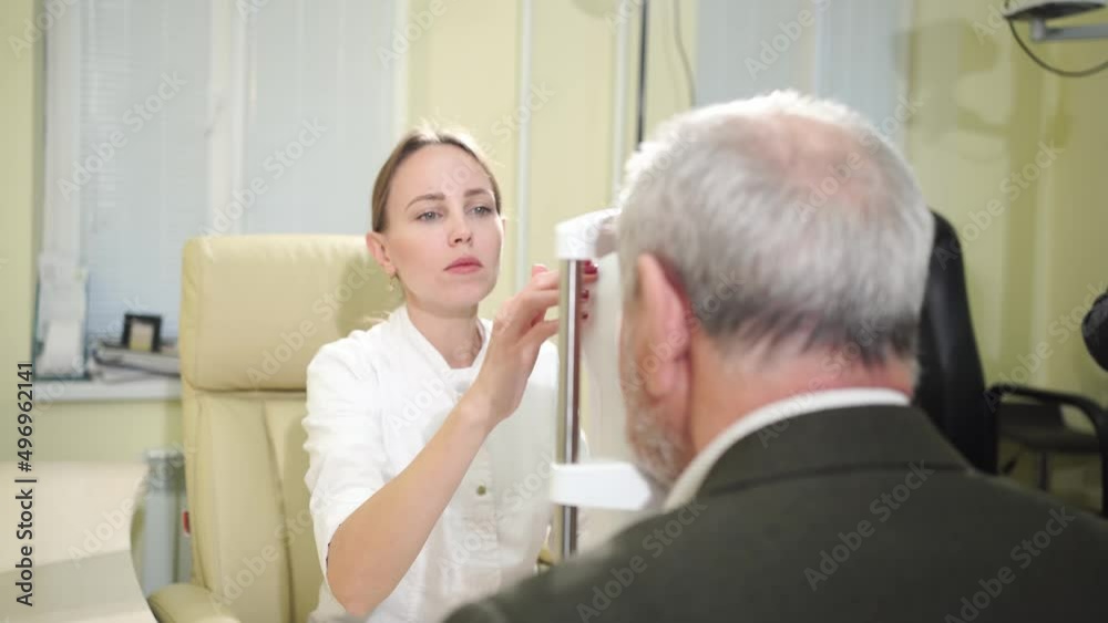 ophthalmologist examination of elderly man on corneo topographer.modern clinic ophthalmologist examination of elderly man on corneo topographer.modern clinic