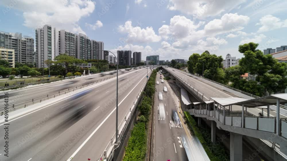 Time-lapse of car and bus traffic transport on multiple lanes highway in Singapore city. Asia transportation system, public commuter lifestyle, Asian city life concept Time-lapse of car and bus traffic transport on multiple lanes highway in Singapore city. Asia transportation system, public commuter lifestyle, Asian city life concept
