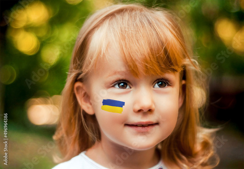 Little girl with the flag of ukraine on her cheek