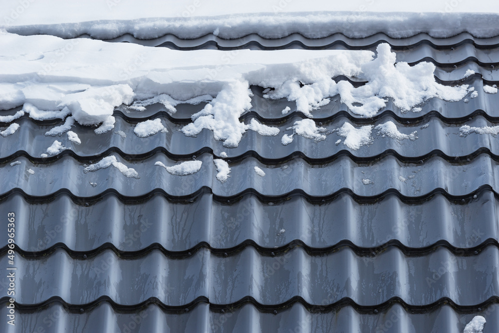 Melting snow on the house roof.