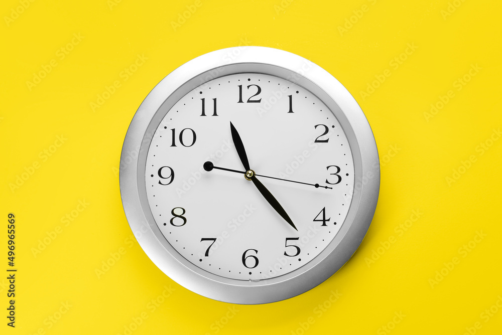 New modern clock on yellow background New modern clock on yellow background