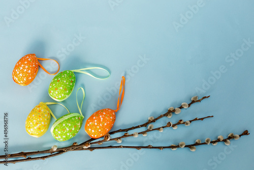 Colorful Easter eggs on a blue background. Place for the inscription. Spring. Easter. Willow.