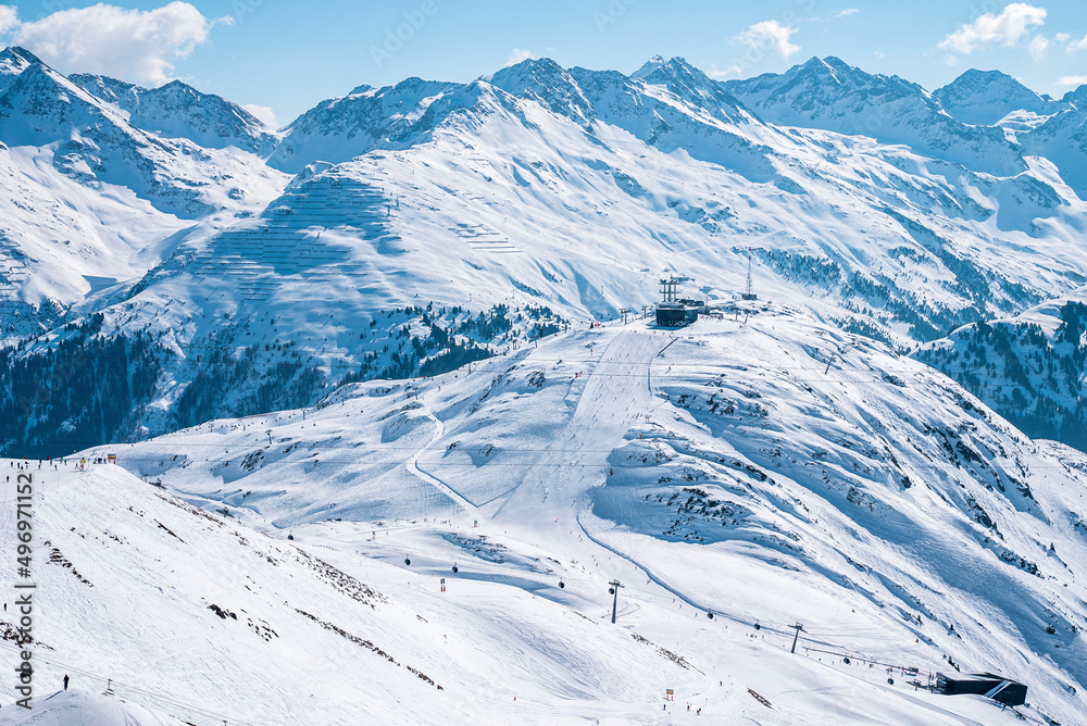 Scenic view of snow covered mountain range. Ski station amidst beautiful white landscape. Beautiful alps during winter.