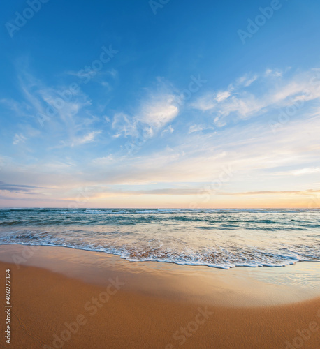 Fototapeta Naklejka Na Ścianę i Meble -  Looking out over the ocean from a deserted beach at dawn or dusk