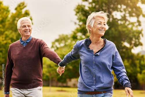 Love keeps a marriage alive. Shot of a happy senior couple going for a walk in the park.