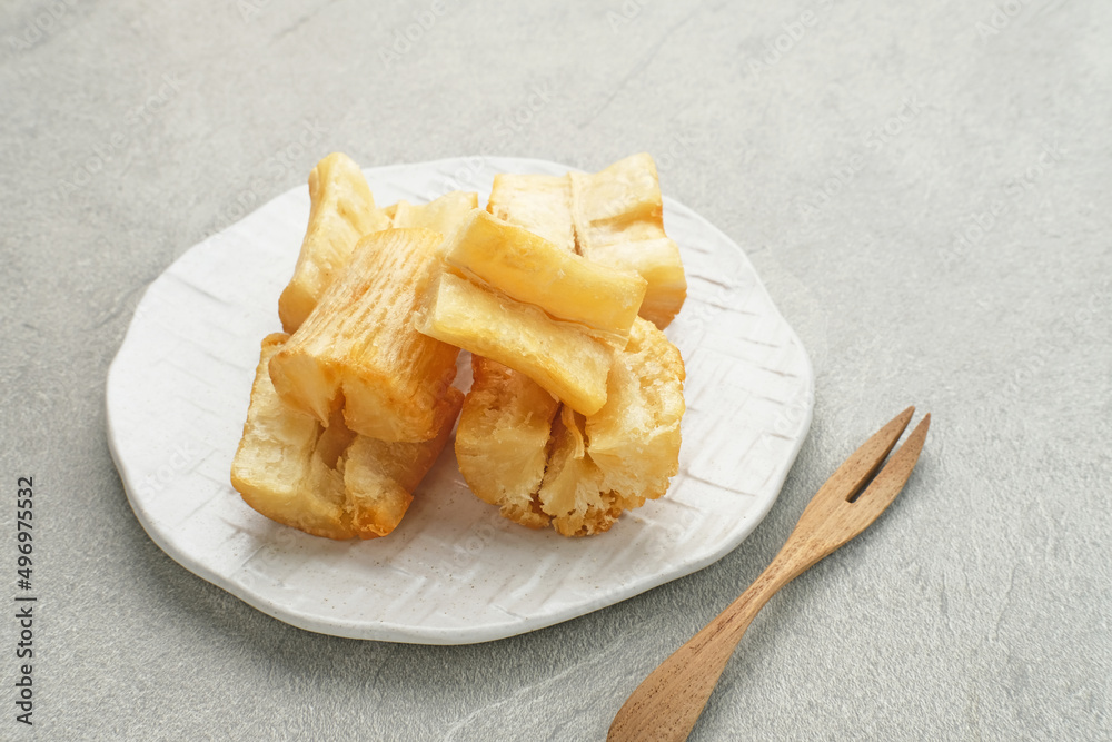 Fried casava or singkong goreng is Indonesian traditional food. Selected focus.
Fried casava or singkong goreng is Indonesian traditional food. Selected focus.