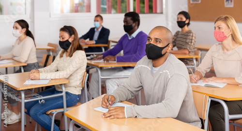 Portrait of adult hispanic man in protective face mask during lesson in extension school. Concept of necessary precautions in COVID pandemic