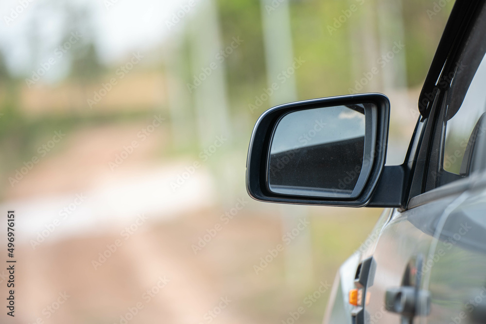 Car driving on the road. Blur Reflection in a car mirror.Rear view mirror reflection.Close up of car mirror with reflection of behind the car.