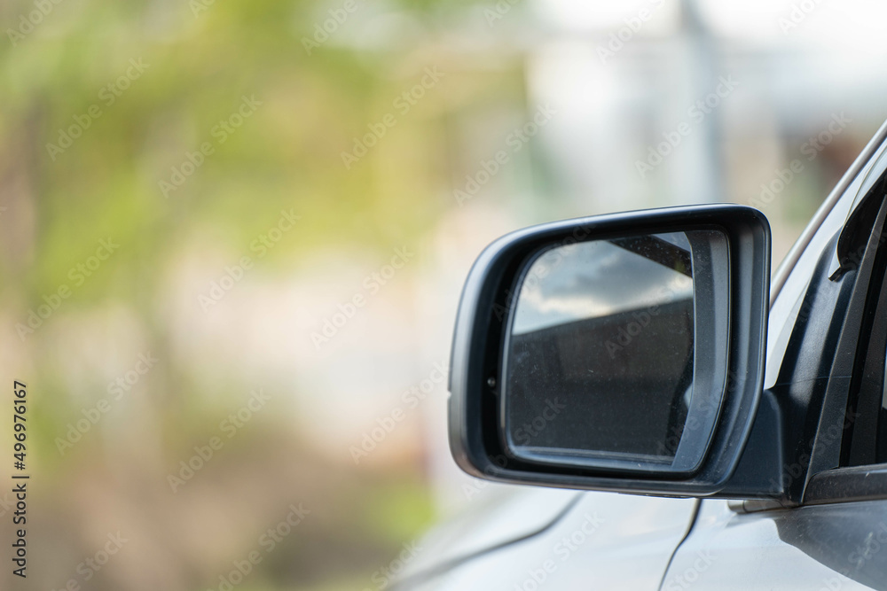 Car driving on the road. Blur Reflection in a car mirror.Rear view mirror reflection.Close up of car mirror with reflection of behind the car.