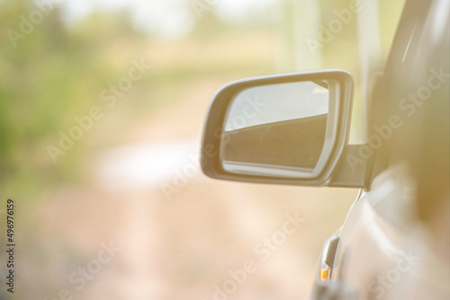 Car driving on the road. Blur Reflection in a car mirror.Rear view mirror reflection.Close up of car mirror with reflection of behind the car.
