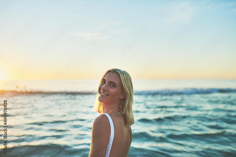 Nothing like fresh ocean air. Cropped portrait of an attractive young female smiling over her shoulder on the beach at sunset. Nothing like fresh ocean air. Cropped portrait of an attractive young female smiling over her shoulder on the beach at sunset.