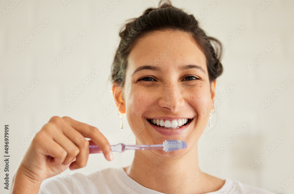 No one ever regrets taking good care of their teeth. Shot of a young woman brushing her teeth. No one ever regrets taking good care of their teeth. Shot of a young woman brushing her teeth.