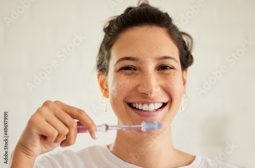 No one ever regrets taking good care of their teeth. Shot of a young woman brushing her teeth.