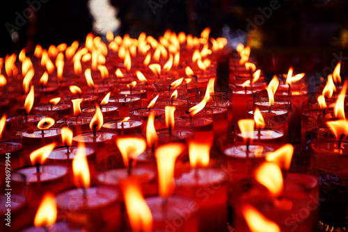 Burning candles at a Buddhist temple.
