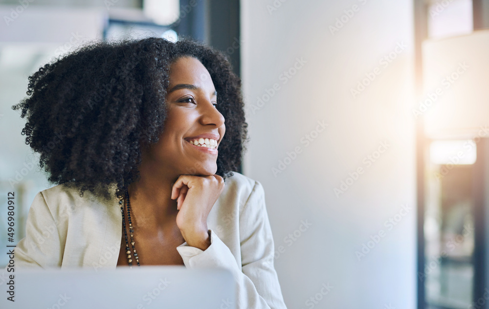 There are so many possibilities to look forward to. Shot of a young businesswoman smiling and looking out of a window in her office. There are so many possibilities to look forward to. Shot of a young businesswoman smiling and looking out of a window in her office.