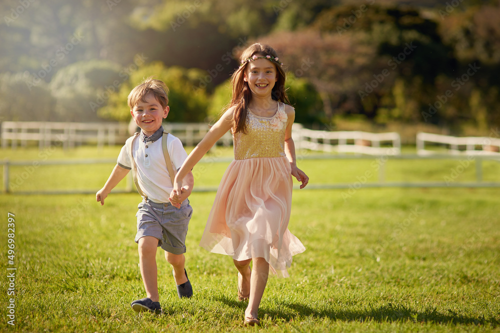 Siblings make the best friends. Portrait of a cute brother and sister running across a field while holding hands. Siblings make the best friends. Portrait of a cute brother and sister running across a field while holding hands.