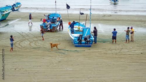 Fishing boats on the beach in Puerto Lopez, Ecuador photo