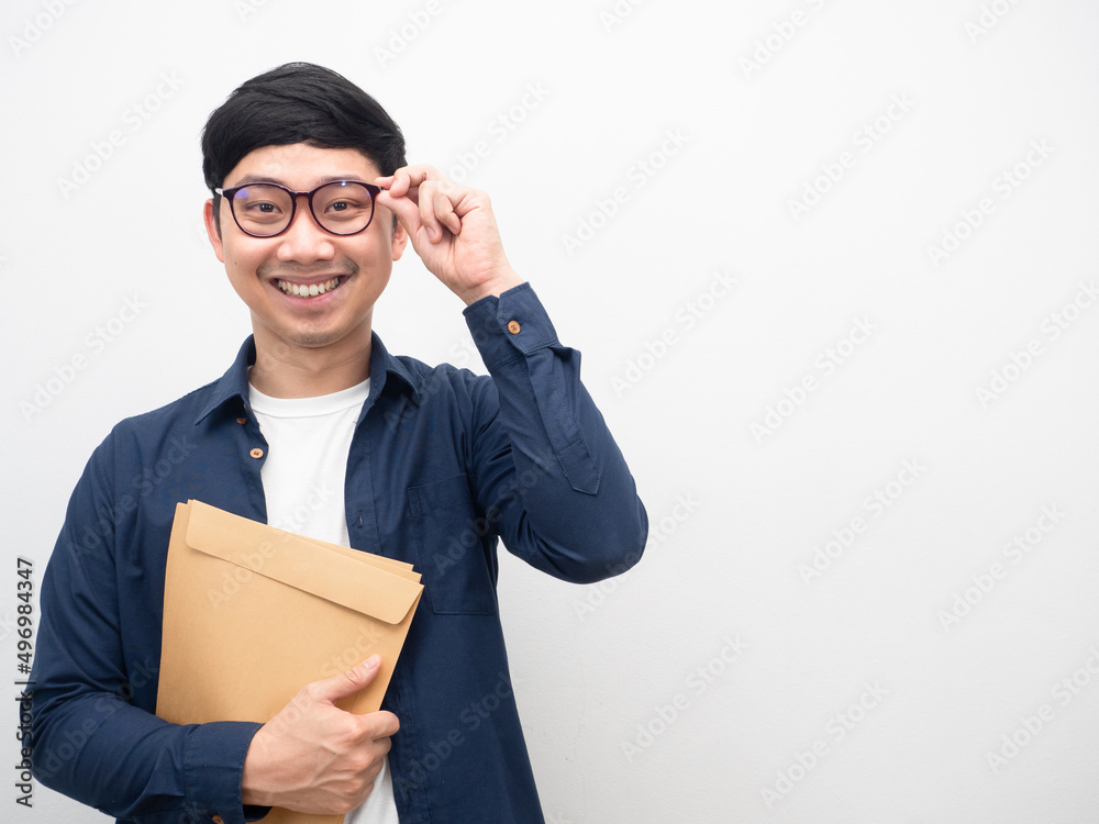 Man wearing glasses holding document envelope happy smile white background Man wearing glasses holding document envelope happy smile white background