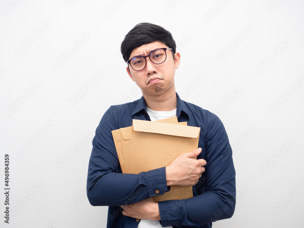 Man wearing glasses holding envelope feeling sad Man wearing glasses holding envelope feeling sad