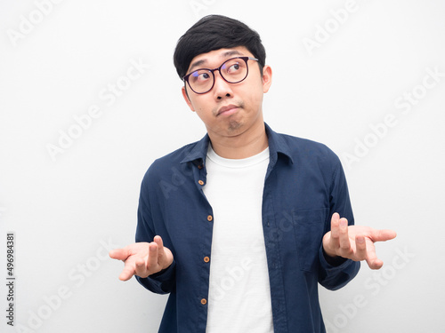 Man wearing glasses feeling bored shrug shoulder white background