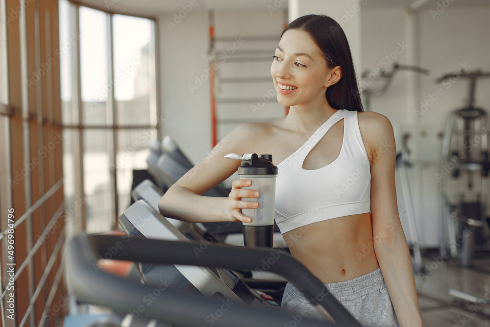 A beautiful girl in a gym on a racetrack A beautiful girl in a gym on a racetrack