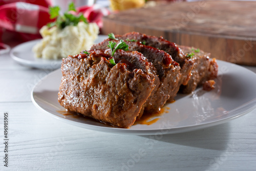 A view of a plate of sliced meatloaf.