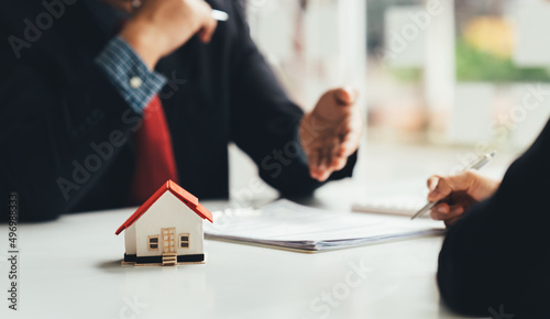 Buying a Home or Insurance, an insurance agent explains the lease agreement to a client before making a contract. Mortgage loan approval home loan and insurance concept.