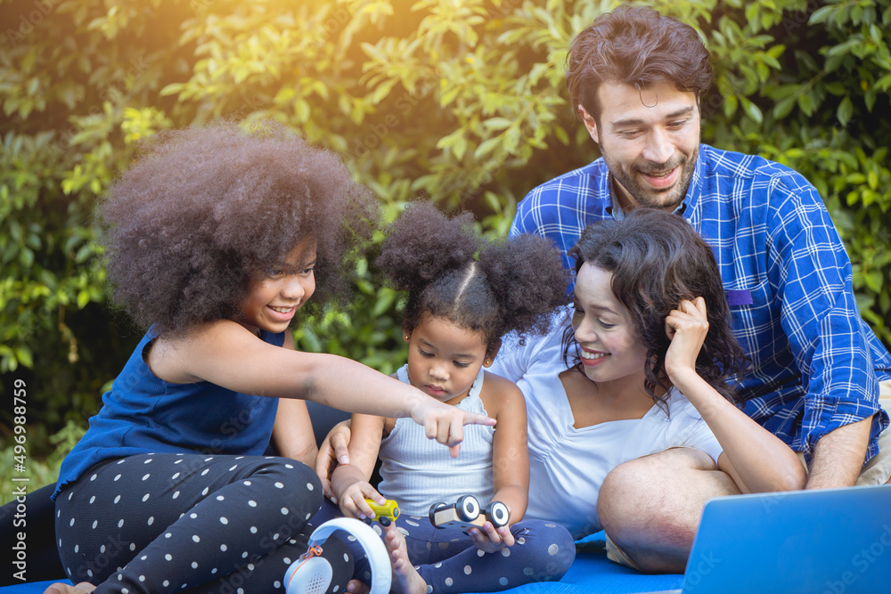 Family happy playing enjoy picnic together in the park garden home backyard.