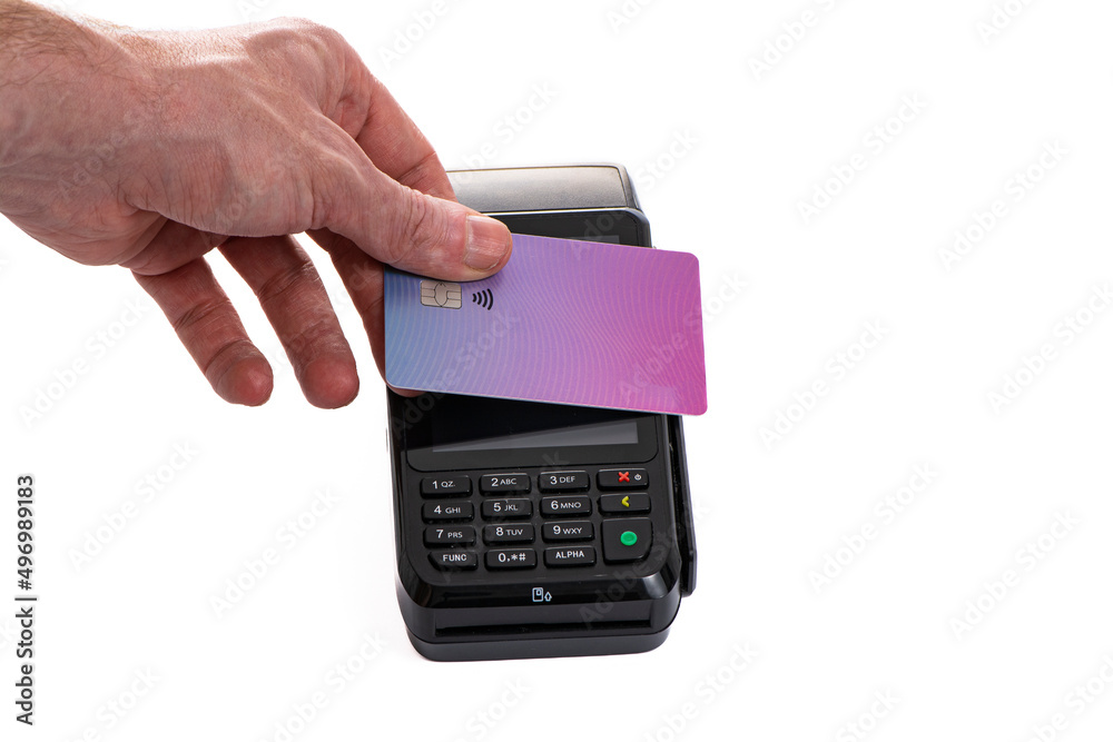 Attached plastic card to the payment terminal with a man's hand on a white isolated background, copy space Attached plastic card to the payment terminal with a man's hand on a white isolated background, copy space