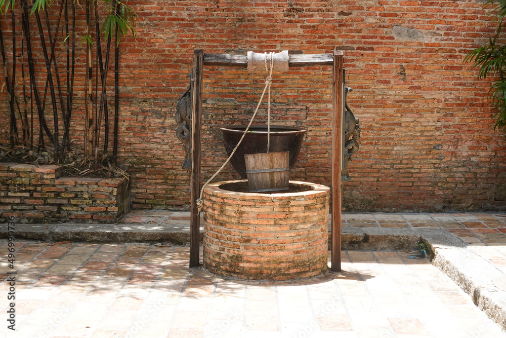 an vintage red brick water well in the courtyard