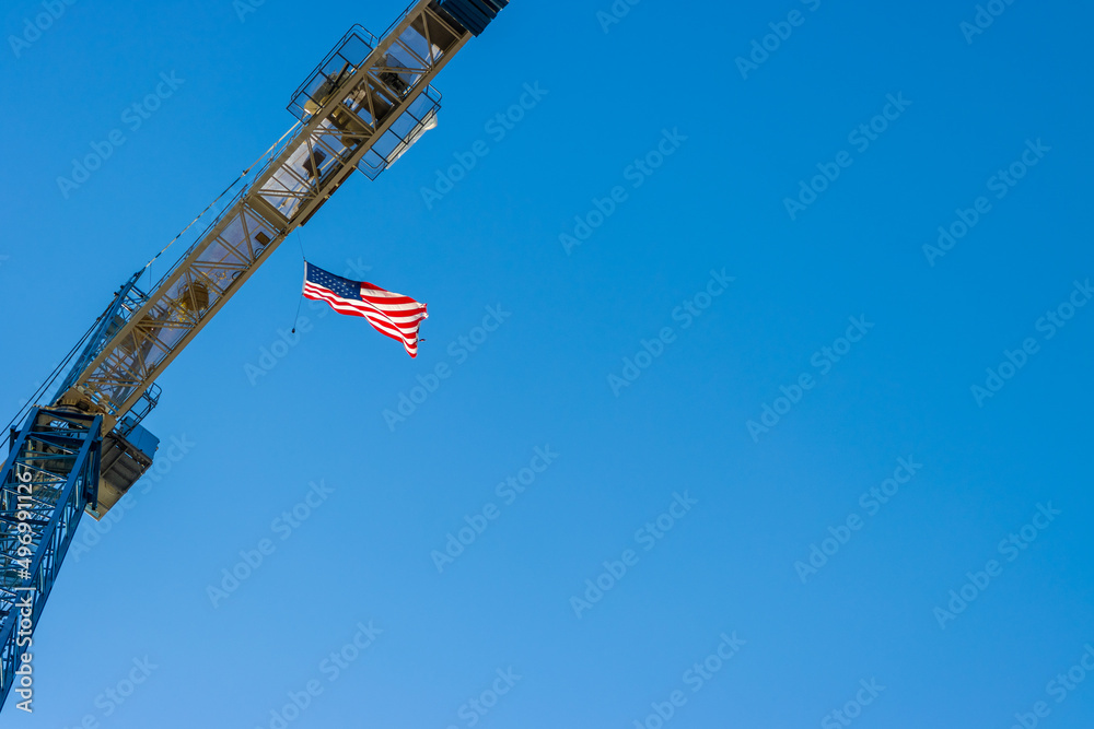 American flag flying from construction crane