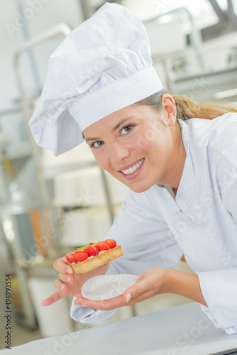 Chef poised to eat a strawberry tart photo