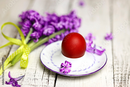 Easter composition with egg and egg cup with Hyacinth spring flowers on wooden background photo