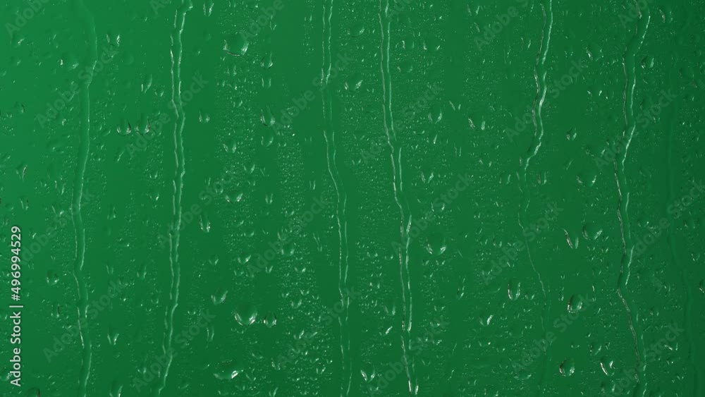 Water rainfall, rain drops falling on window glass over chroma key green screen Water rainfall, rain drops falling on window glass over chroma key green screen