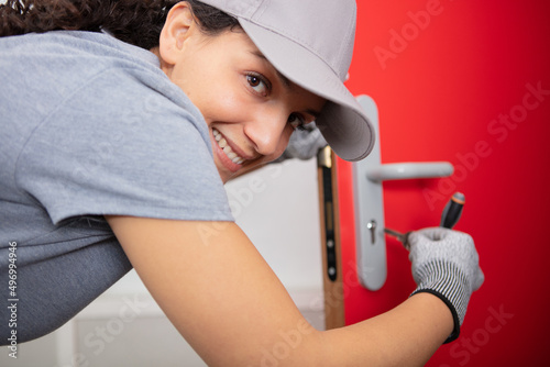 woman repairing a door lock
