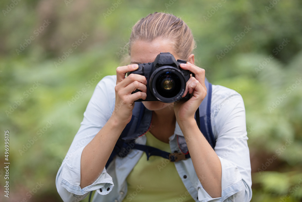 woman in rural setting looking through camera viewfinder woman in rural setting looking through camera viewfinder