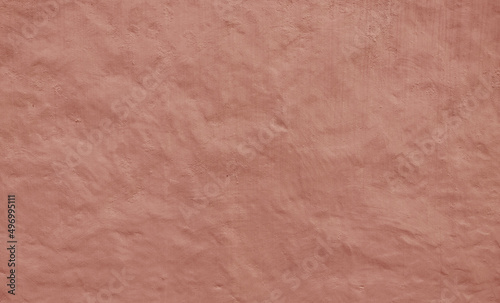 Stucco painted wall background texture, brown color, exterior building facade, Abstract panorama image of Orange clay wall grunge texture background for interior decoration.