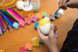 Kid are painting Easter eggs. Preparing decorations for Easter, creativity with children, traditional symbols. Preparing for Easter.