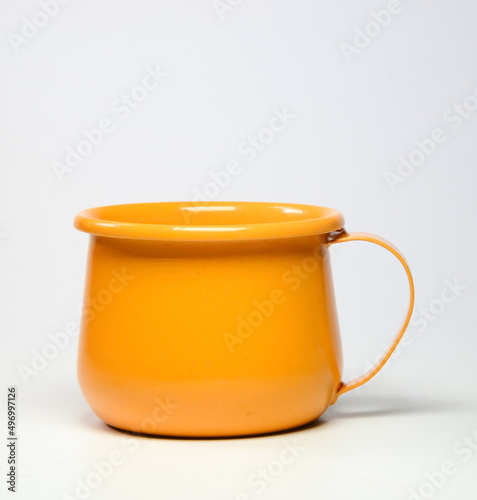 Zinc glass bright orange on a white background. Ideas for mock ups...Blank mock up Empty classic undervest mug with neckline mockup, isolated.