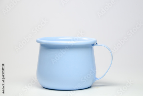 Zinc mug, bright light blue on white background. Blank mockup idea for a classic undervest empty cup.