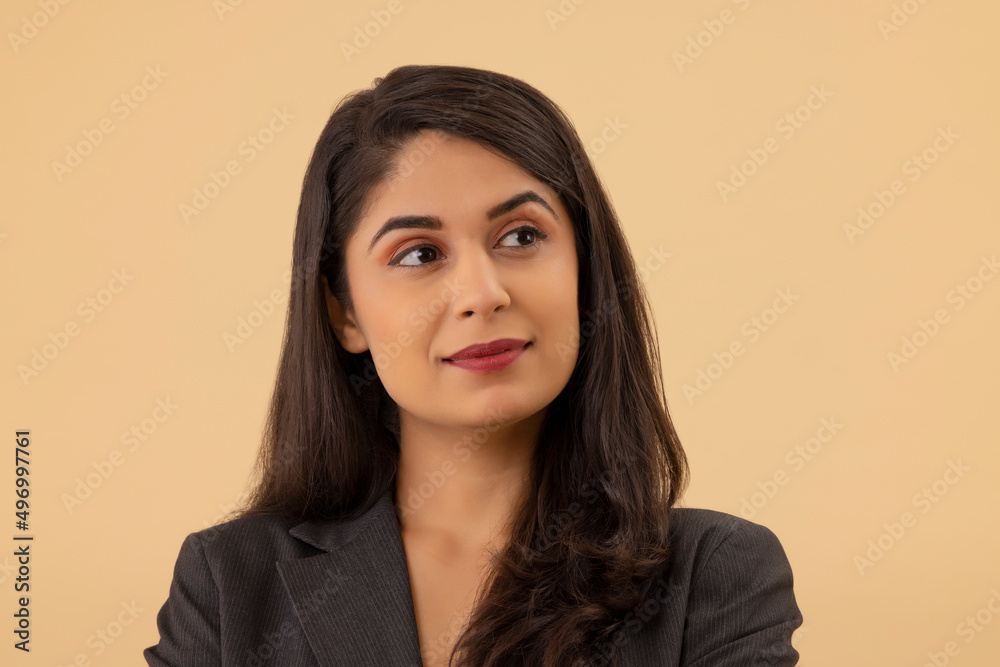 Close-up portrait of a young businesswoman looking elsewhere Close-up portrait of a young businesswoman looking elsewhere