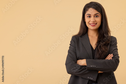 Portrait of a young businesswoman looking at the camera with arms crossed photo