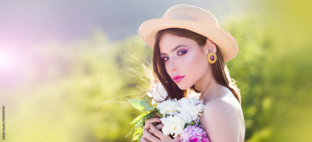 Fototapeta premium Natural beauty face. Beautiful romantic young woman in spring flowers posing on a blossom background. Inspiration of spring and summer. Banner for header website design, copy space.