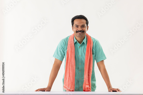 Portrait of middle aged servant with towel around his neck