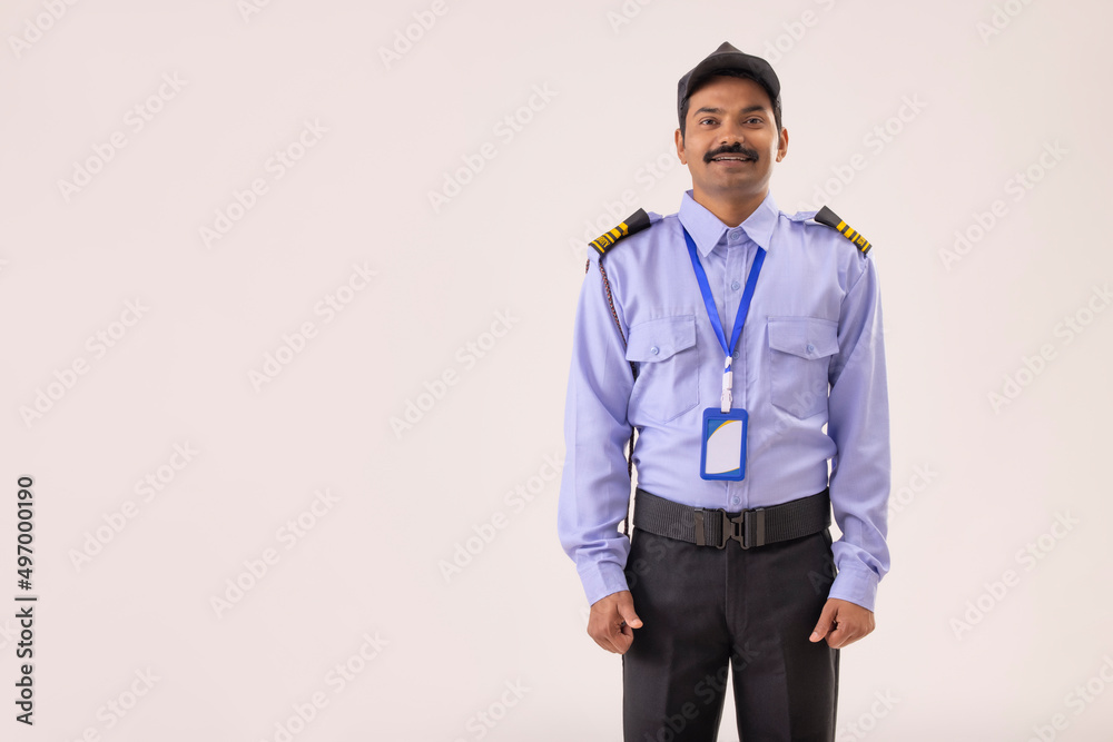 Portrait of male security guard standing in uniform Portrait of male security guard standing in uniform